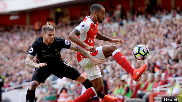 Arsenal's Theo Walcott in action with Liverpool's Alberto Moreno