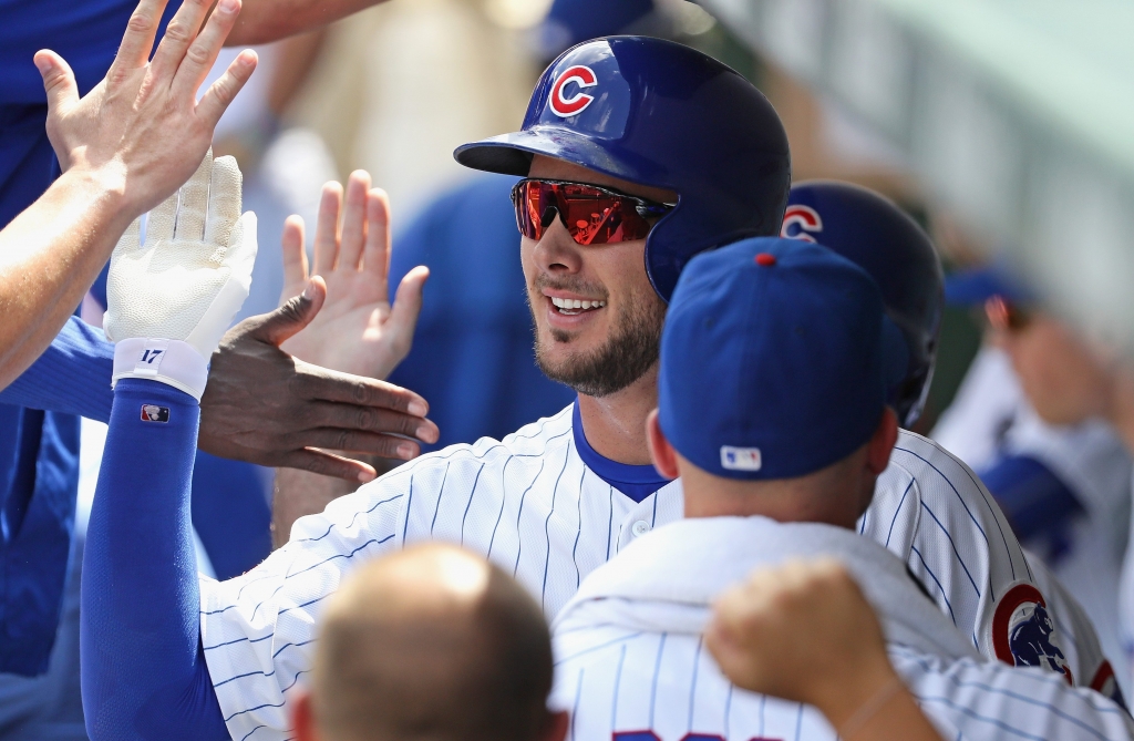 Kris Bryant is congratulated by Cubs teammates after homering