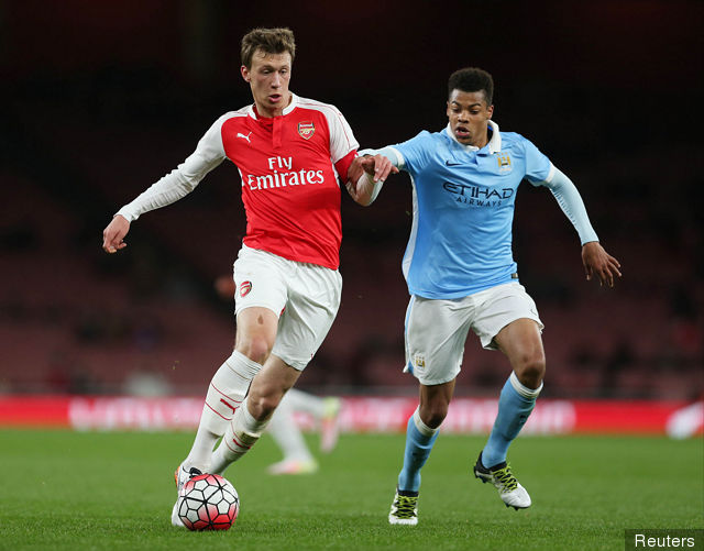 Arsenal's Krystian Bielik and Manchester City's Lukas Nmecha in action