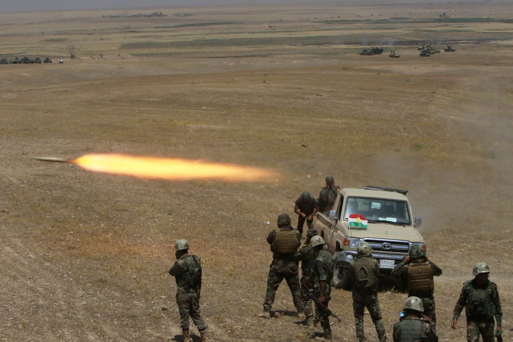 Kurdish Peshmerga forces fire a rocket toward Islamic State terrorists on the southeast of Mosul, Iraq on Sunday