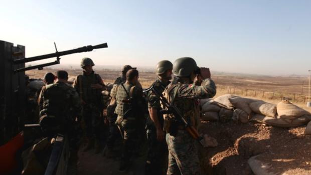 Kurdish Peshmerga forces keep watch in a village east of Mosul Iraq