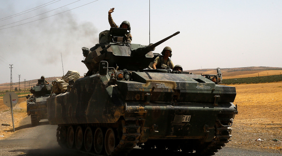 A Turkish soldier on an armoured personnel carrier waves as they drive from the border back to their base in Karkamis on the Turkish Syrian border in the southeastern Gaziantep province Turkey