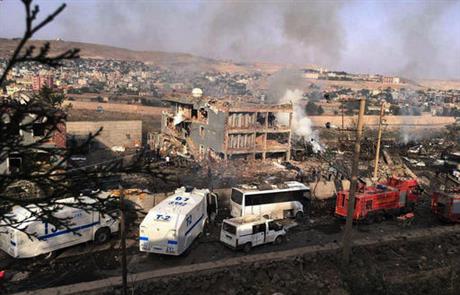 Smoke still rises from the scene after Kurdish militants attacked a police checkpoint in Cizre southeast Turkey Friday Aug. 26 2016 with an explosives-laden truck killing several police officers and wounding dozens more according to reports from