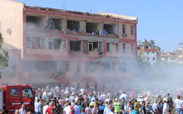 People rush to the blast scene after a car bomb attack on a police station in the eastern Turkish city of Elazig Turkey