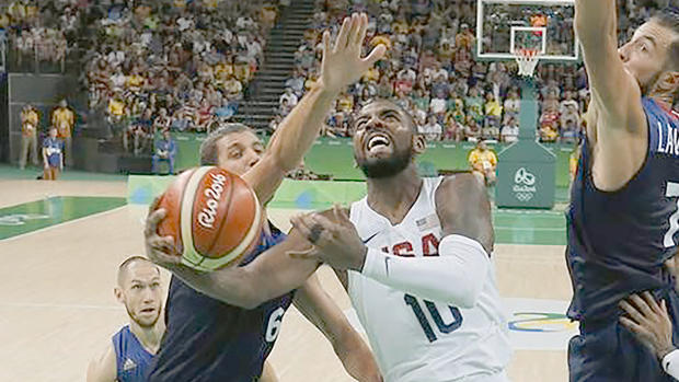 Kyrie Irving of the U.S. makes a layup as Antoine Diot and Joffrey Lauvergne of France defend Sunday in Rio de Janeiro. Jim Young  Reuters