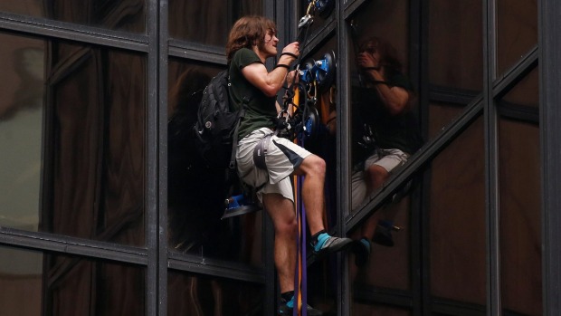 A man climbs the outside of Trump Tower in New York