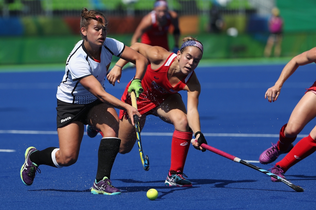 RIO DE JANEIRO BRAZIL- AUGUST 15 Lisa Altenburg #18 of Germany moves the ball past Alyssa Manley #29 of United States during the quarter final hockey game on Day 10 of the Rio 2016 Olympic Games at the Olympic Hockey Centre