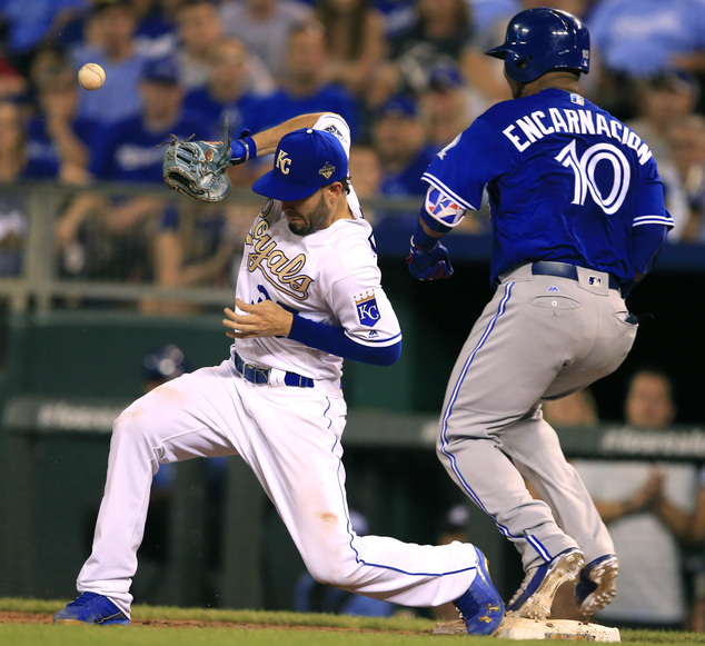 Toronto Blue Jays designated hitter Edwin Encarnacion beats out the throw to Kansas City Royals first baseman Eric Hosmer for an infield hit during