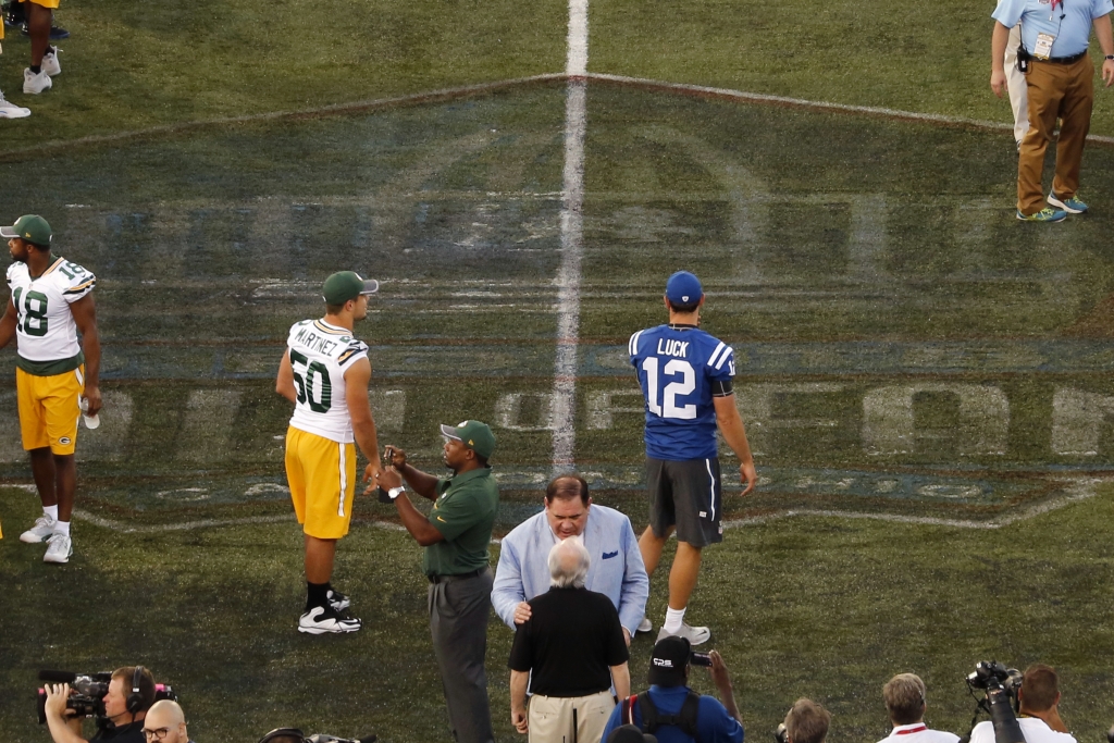 Indianapolis Colts&#039 Andrew Luck and Green Bay Packers&#039 Blake Martinez, center meet a midfield after the preseason NFL football game between the Green Bay Packers and the Indianapolis Colts at Tom Benson Hall of Fame Stadium was cancel