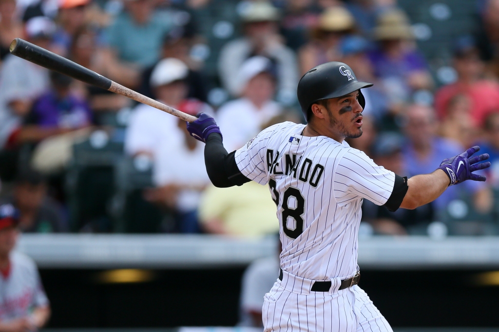 DENVER CO- AUGUST 17 Nolan Arenado #28 of the Colorado Rockies watches his RBI sac-fly during the fifth inning against the Washington Nationals at Coors Field