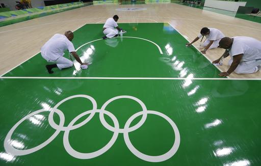 Work crews clean the basketball floor during an off day for women's basketball at the Youth Center at the 2016 Summer Olympics in Rio de Janeiro Brazil Friday Aug. 5 2016. The women's competition begins on Saturday