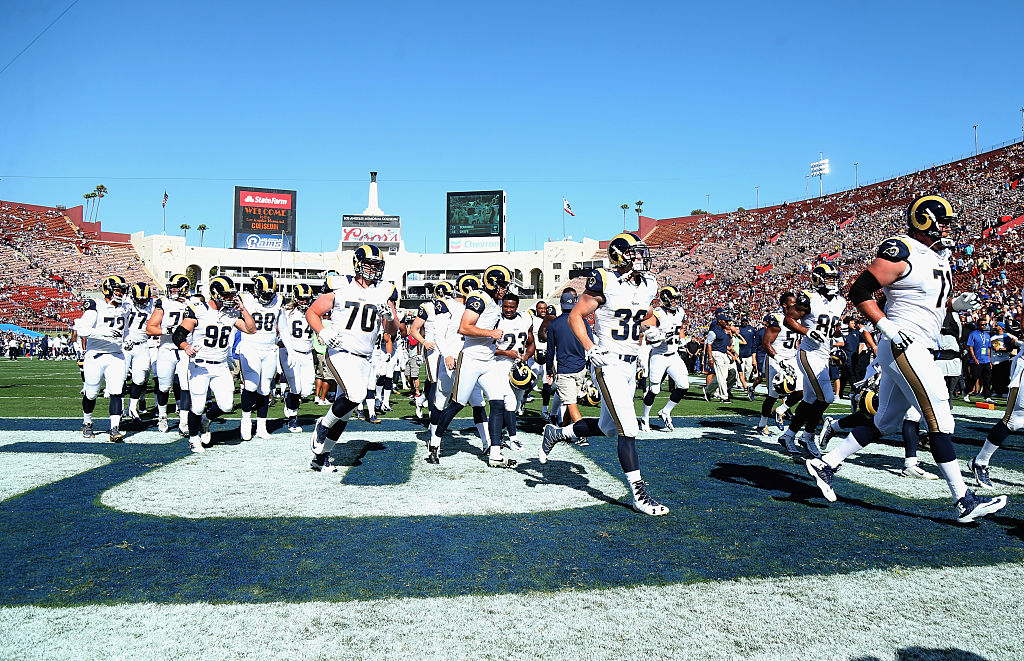 LOS ANGELES CA- AUGUST 13 The Los Angeles Rams run off the field after warmups for their game with the Dallas Cowboys at the Los Angeles Coliseum during preseason