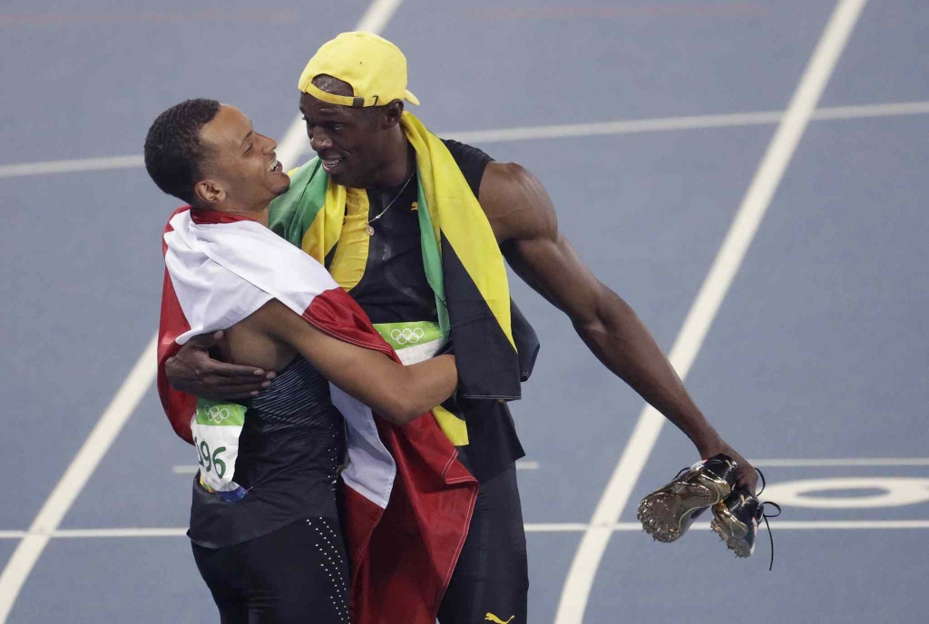 Jamaica's Usain Bolt right celebrates winning the men's 100-meter final with third placed Canada's Andre De Grasse during the athletics competitions of the 2016 Summer Olympics at the Olympic stadium in Rio de Janeiro Brazil Sunday Aug. 1