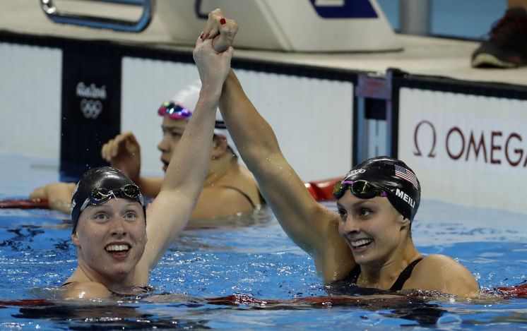 Americans Lilly King left who earned the gold medal and bronze medalist Katie Meili celebrate after their performance in the 100-meter breaststroke