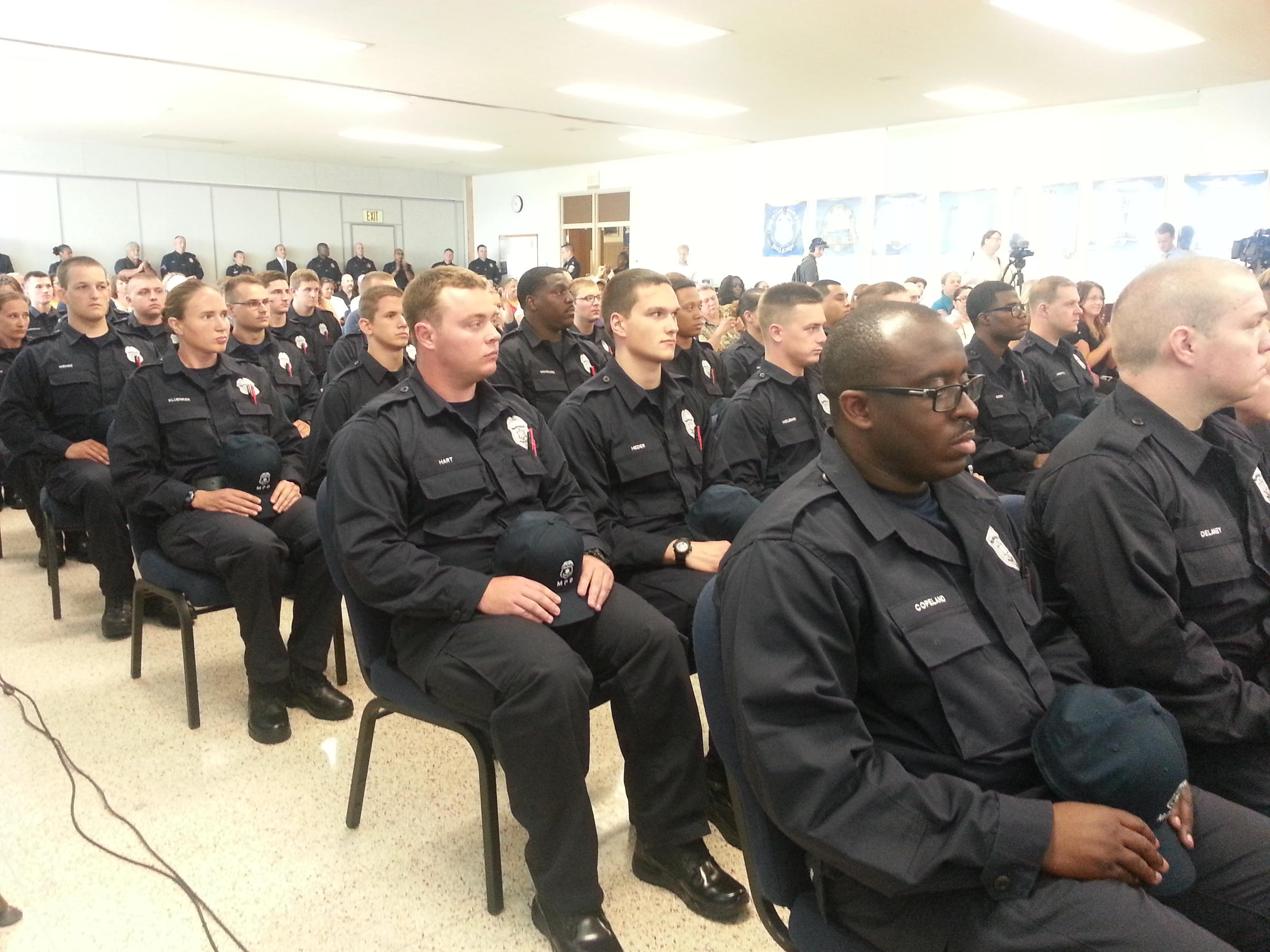 Several dozen police cadets attend their swearing-in ceremony on Monday