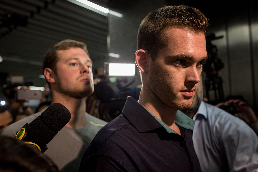 U.S Olympic swimmers Gunnar Bentz and Jack Conger leave the police headquarters at International departures of Rio de Janiero's Galeo International airport