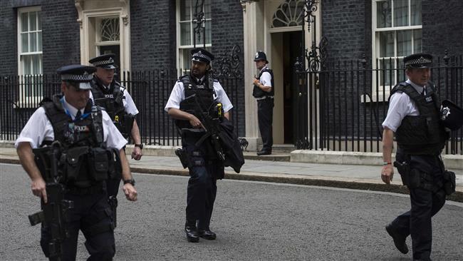 Armed British police officers patrol near 10 Downing Street the official residence of British Prime Minister Theresa May in central London