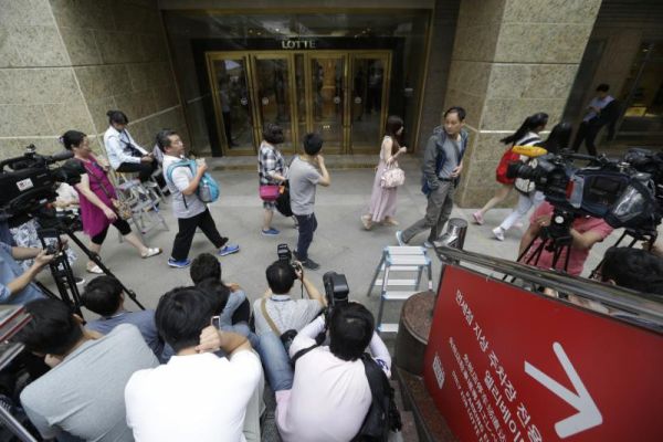 People pass by Lotte Group office in Seoul