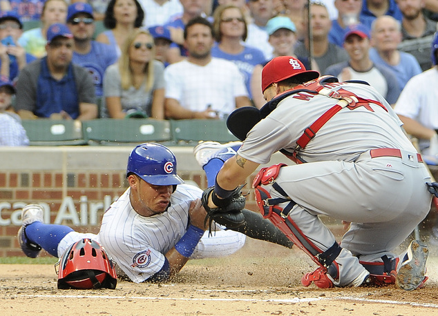 St. Louis Cardinals catcher Yadier Molina right tags out Chicago Cubs Willson Contreras left at home plate during the second inning of a baseball game