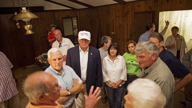 Republican presidential candidate Donald Trump center and his running mate Indiana Gov. Mike Pence listens to flood victims Jimmy and Olive Gordan during a tour of their flood damaged home in Denham Springs La. Friday Aug. 19 2016. (AP