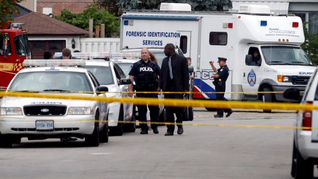 A Forensic Identification Services truck arrives at the a house where three pople have died in an incident involving