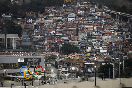 The Olympic rings adorn the Maracana Stadium ahead of the opening ceremony for the 2016 Summer Olympics in Rio de Janeiro Brazil Friday Aug. 5 2016 as the city's hillside slums are visible