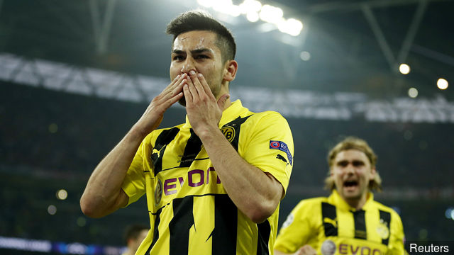 Ilkay Gundogan celebrates after scoring the first goal for Borussia Dortmund from the penalty spot