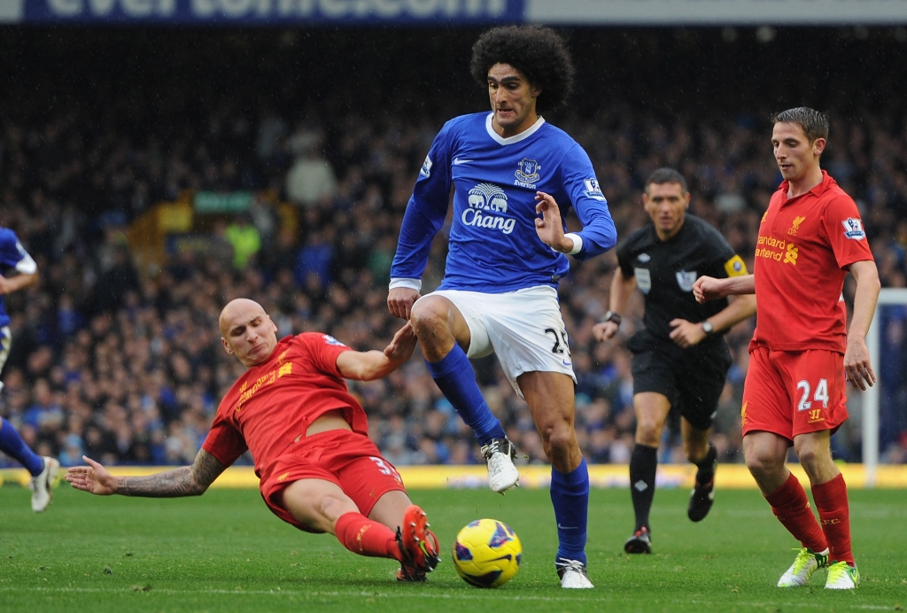 LIVERPOOL ENGLAND- OCTOBER 28 Marouane Fellaini of Everton is challenged by Jonjo Shelvey of Liverpool during the Barclays Premier League match between Everton and Liverpool at Goodison Park