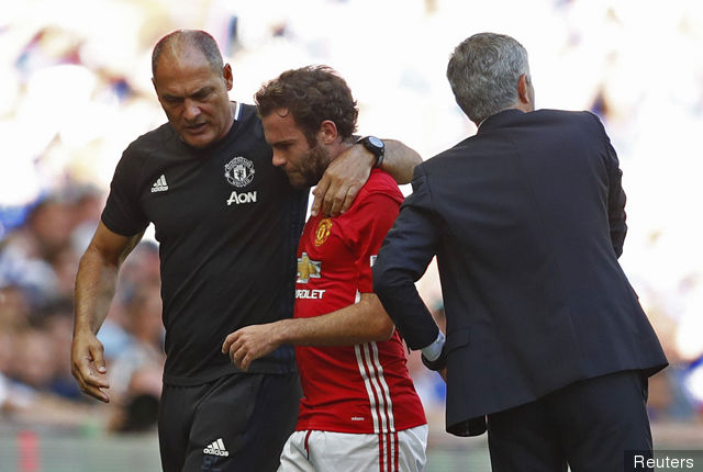 Manchester United manager Jose Mourinho talks to reporters during the team's recent China visit