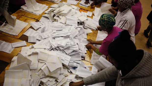 Election officials start the ballot counting process at a polling station during municipal elections in Manenberg on the outskirts of Cape Town South Africa