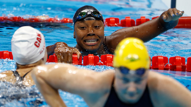 Simone Manuel of the United States and Penny Oleksiak of Canada celebrate winning joint gold in the Women's 100m Freestyle Final on Day 6 of the Rio 2016 Olympic Games at the Olympic Aquatics Stadium