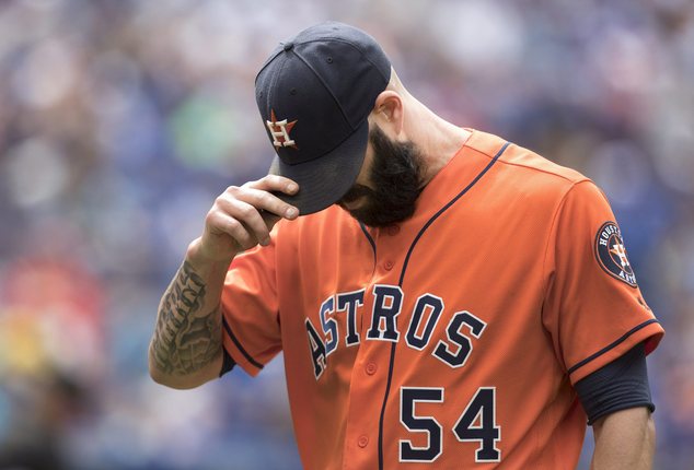 Houston Astros starting pitcher Mike Fiers pulls his cap down as leaves the field after giving up back-to-back home runs to the Toronto Blue Jays during the