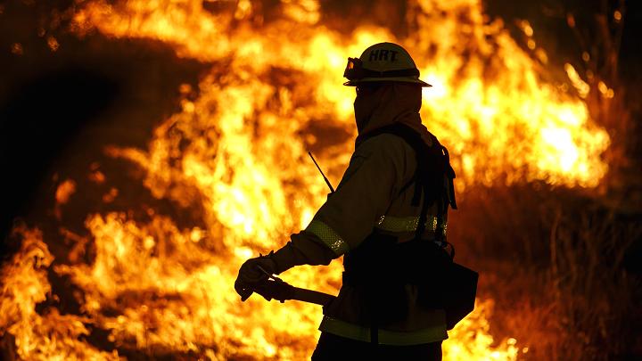 Firefighters monitor the Blue Cut fire burning alongside Lytle Creek Road in San Bernardino County Calif. on Aug. 17 2016