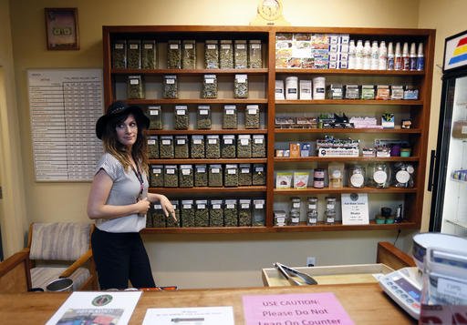 Assistant manager Jaclyn Stafford works behind the sales counter at The Station a retail and medical cannabis dispensary in Boulder Colo. Thursday Aug. 11 2016. The DEA announced Thursday Aug. 11 2016 that the Obama administration will keep mariju