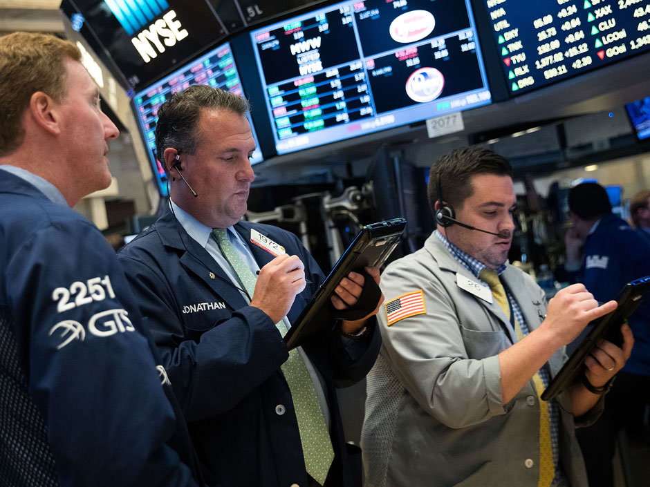 Traders work on the floor of the New York Stock Exchange