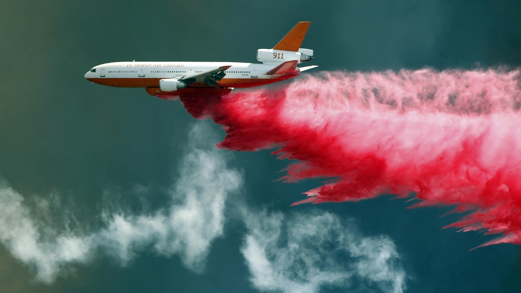 An air tanker fights California's Bluecut wildfire with flame retardant. Fire experts say Bluecut has burned and spread with a ferocity they've never seen before