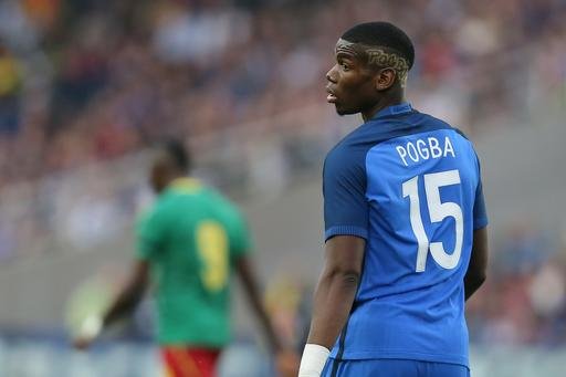 France's Paul Pogba looks on during a friendly soccer match between France and Cameroon at the La Beaujoire Stadium in Nantes western France. Manchester United says Paul Pogba has been granted permission