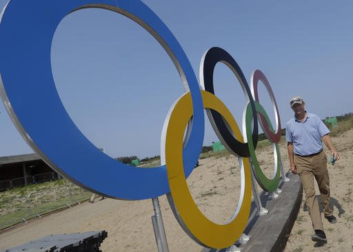 Designer of the Olympic golf course Gil Hanse walks past a set of olympic rings near the first tee on the course for the 2016 Summer Olympics in Rio de Janeiro Brazil Tuesday Aug. 9 2016