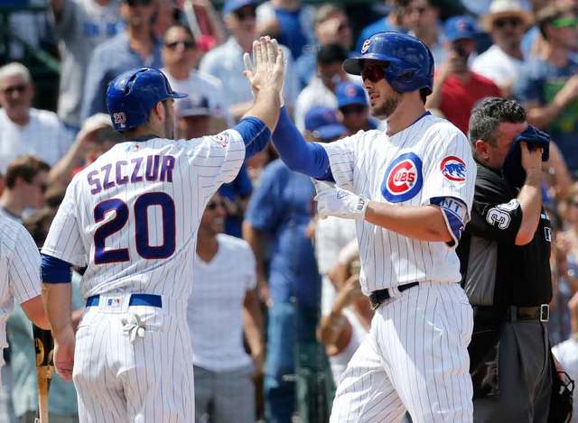 Matt Szczur greeted Kris Bryant after Bryant hit a two-run home run. Charles Rex Arbogast  AP Click