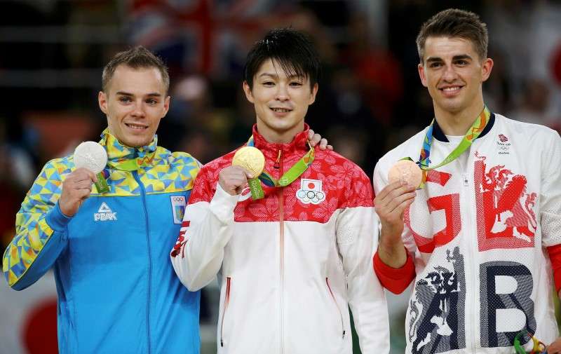 2016 Rio Olympics- Artistic Gymnastics- Men's Individual All Around Victory Ceremony- Rio Olympic Arena- Rio de Janeiro Brazil- 10/08/2016. Gold medallist Kohei Uchimura of Japan, silver medallist Oleg Verniaiev of Ukraine and