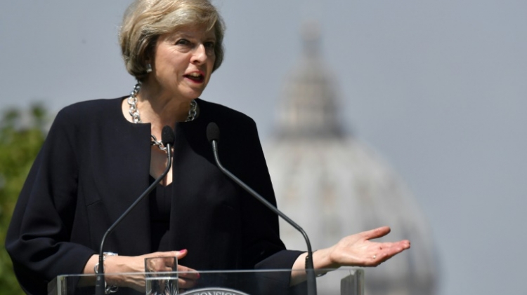 British Prime Minister Theresa May speaks with journalists during a press conference in the garden of Villa Doria Pamphili in Rome