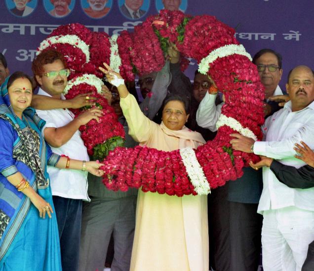 Supporters greet Bahujan Samaj Party chief Mayawati during a mega rally in Agra on Sunday