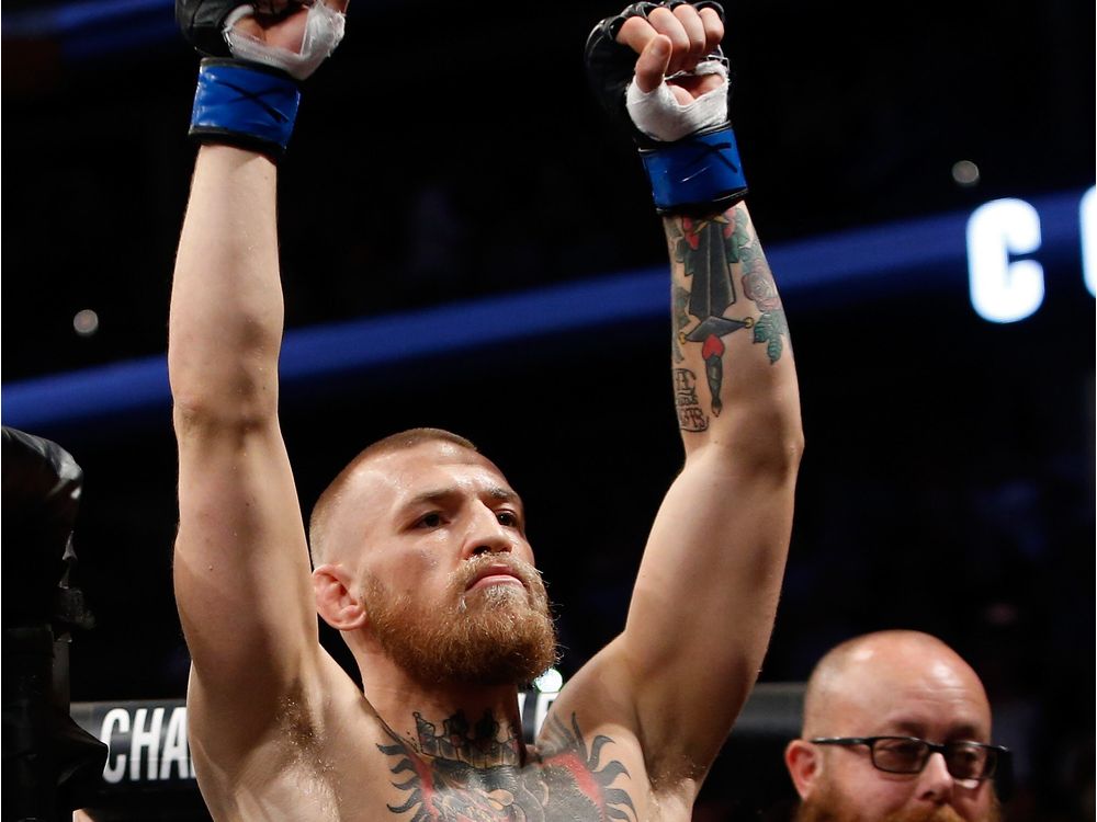 Conor Mc Gregor gestures as he arrives for his welterweight rematch against Nate Diaz at the UFC 202 event at T Mobile Arena