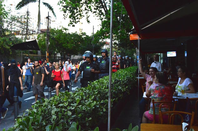 Meg Healy   Restaurant patrons look on as protesters march through the Tijuca neighborhood near Maracanã Stadium in Rio de Janeiro Brazil