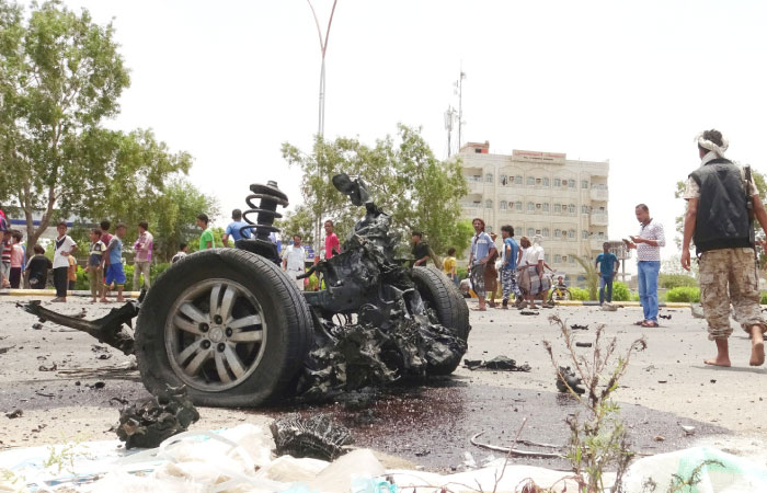 Members of the Southern Resistance militia gather at the site of a car bomb attack in the southern port city of Aden on Sunday. — Reuters