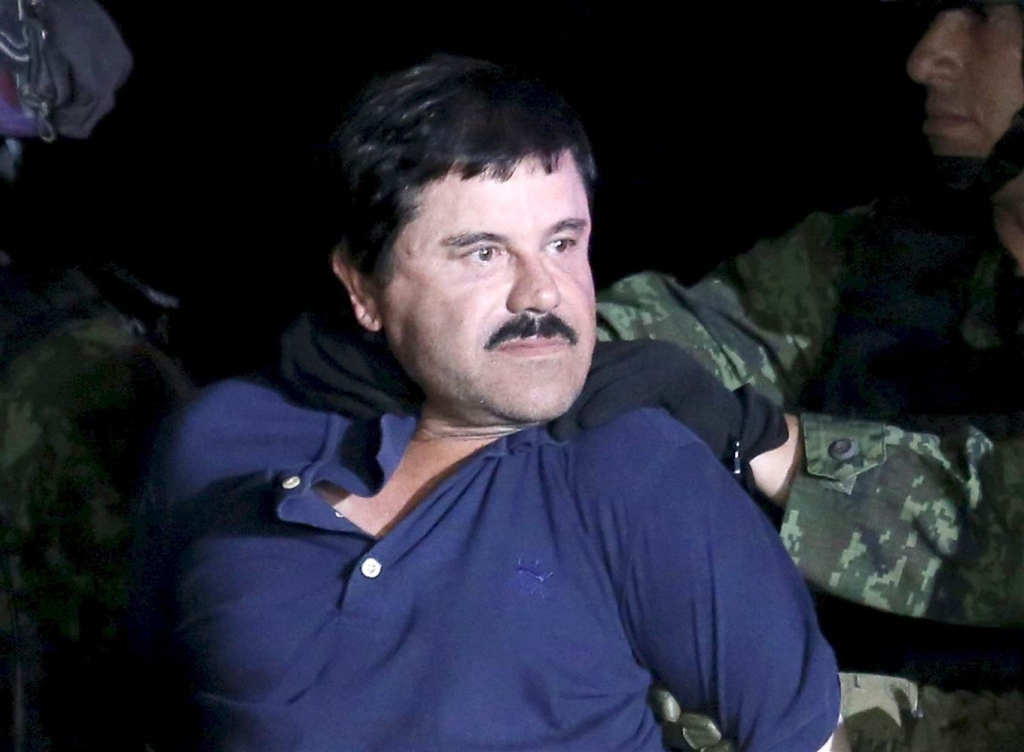 Image Recaptured drug lord Joaquin'El Chapo Guzman is escorted by soldiers during a presentation in Mexico City