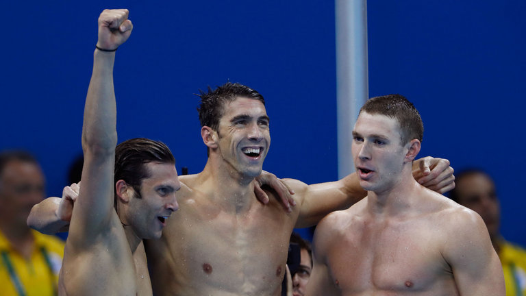 Michael Phelps celebrates with Cody Miller and new 100m backstroke record holder Ryan Murphy