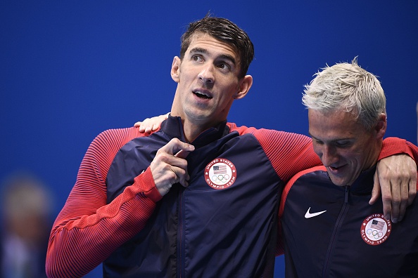 USA's Michael Phelps and USA's Ryan Lochte celebrate on the podium after they won the Men's 4x200m Freestyle Relay Final during the swimming event at the Rio 2016 Olympic Games at the Olympic Aquatics Stadium in Rio de Janeiro on August