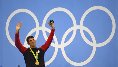 Michael Phelps celebrates his win with fiance Nicole Johnson and baby Boomer. AP