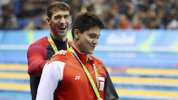 2016 Rio Olympics- Swimming- Victory Ceremony- Men's 100m Butterfly Victory Ceremony- Olympic Aquatics Stadium- Rio de Janeiro Brazil- 12/08/2016. Joseph Schooling of Singapore is congratulated by Michael Phelps of USA as they leave the